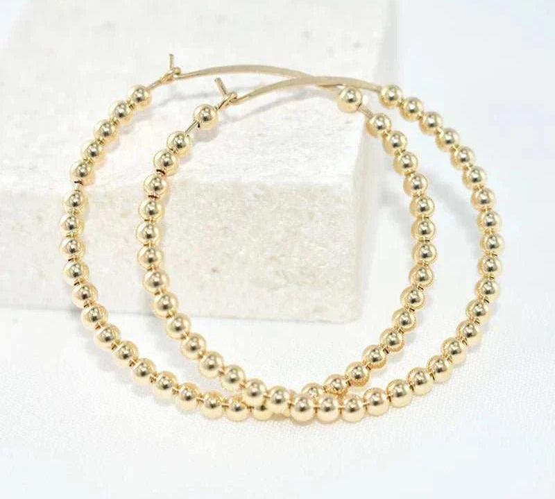 14K gold-filled everyday hoops with a classic design, tarnish-resistant, and hypoallergenic.