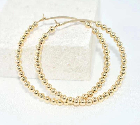 14K gold-filled everyday hoops with a classic design, tarnish-resistant, and hypoallergenic.