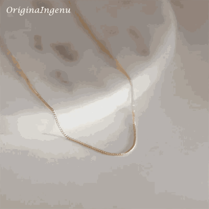 14K gold filled liquid chain necklace on marble background.