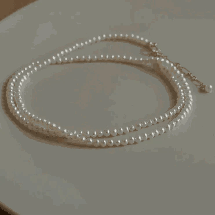14K Gold Pearl Choker Necklace with lustrous pearls and gold-filled elements displayed on a neutral background.