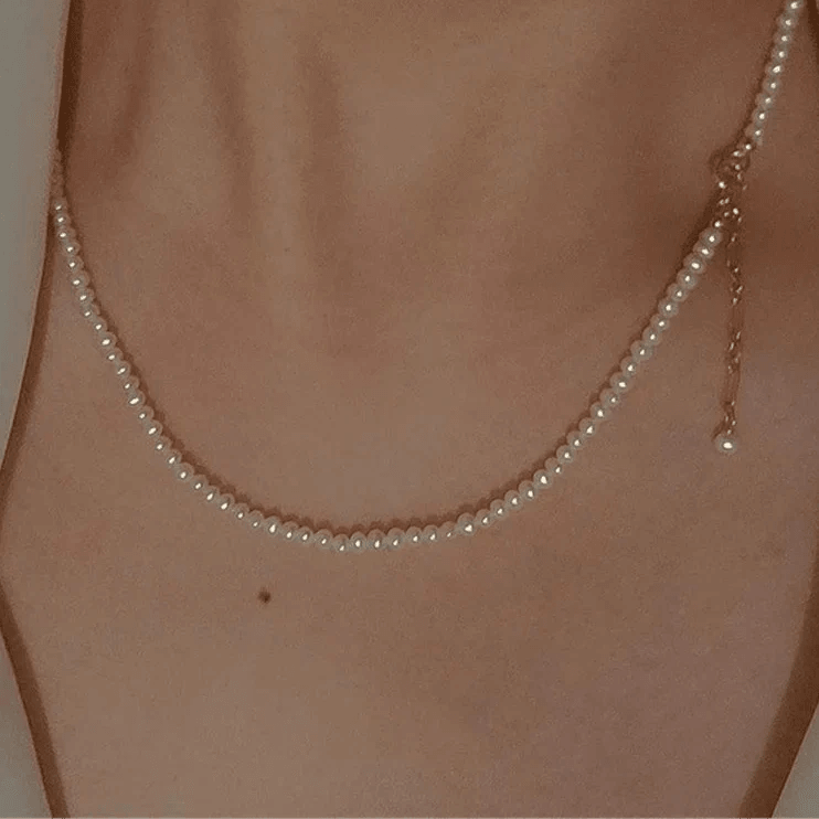 14K Gold Pearl Choker Necklace with lustrous pearls and gold accents.