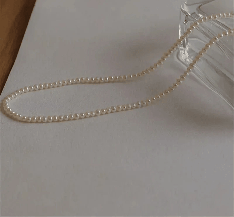 14K Gold Pearl Choker Necklace with lustrous pearls and gold accents.