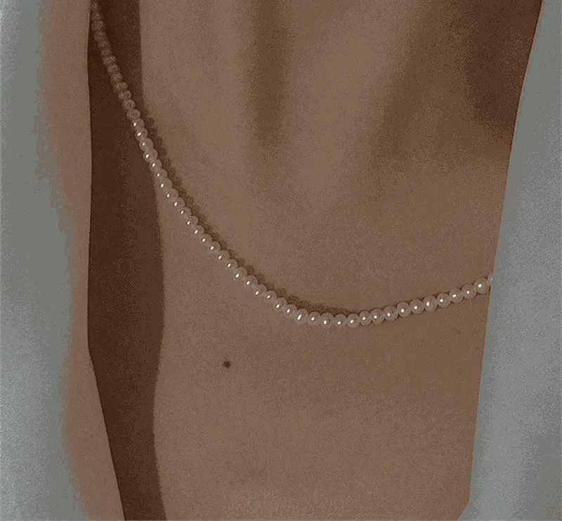 14K Gold Pearl Choker Necklace featuring lustrous pearls on a neckline.