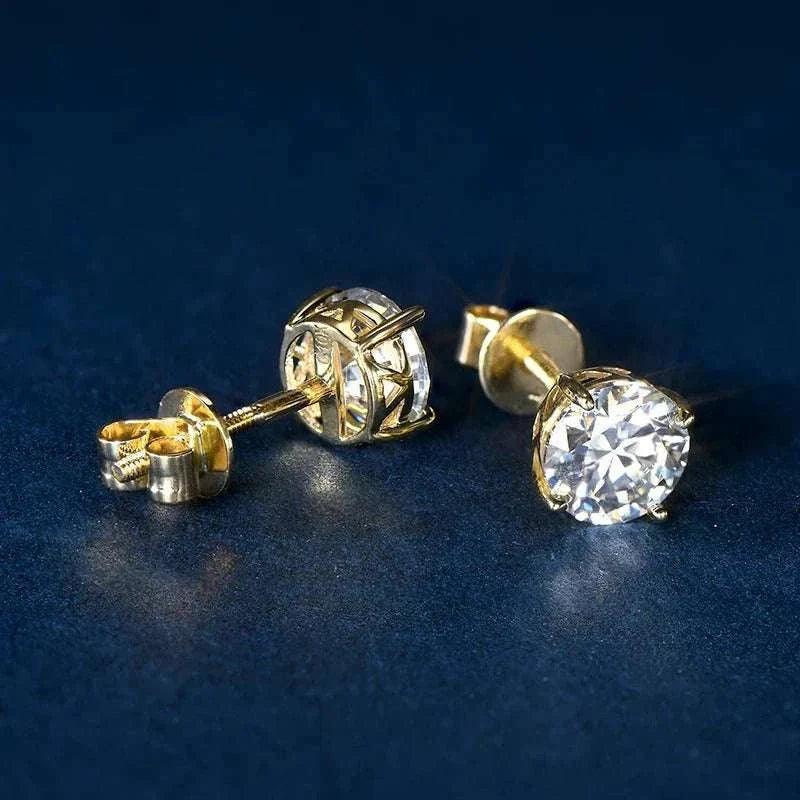 14k gold moissanite stud earrings for men and women on dark background.