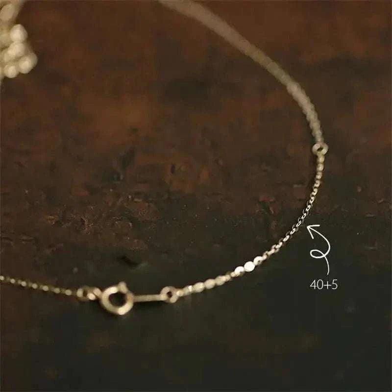 14K solid gold minimalist necklace with delicate chain design.