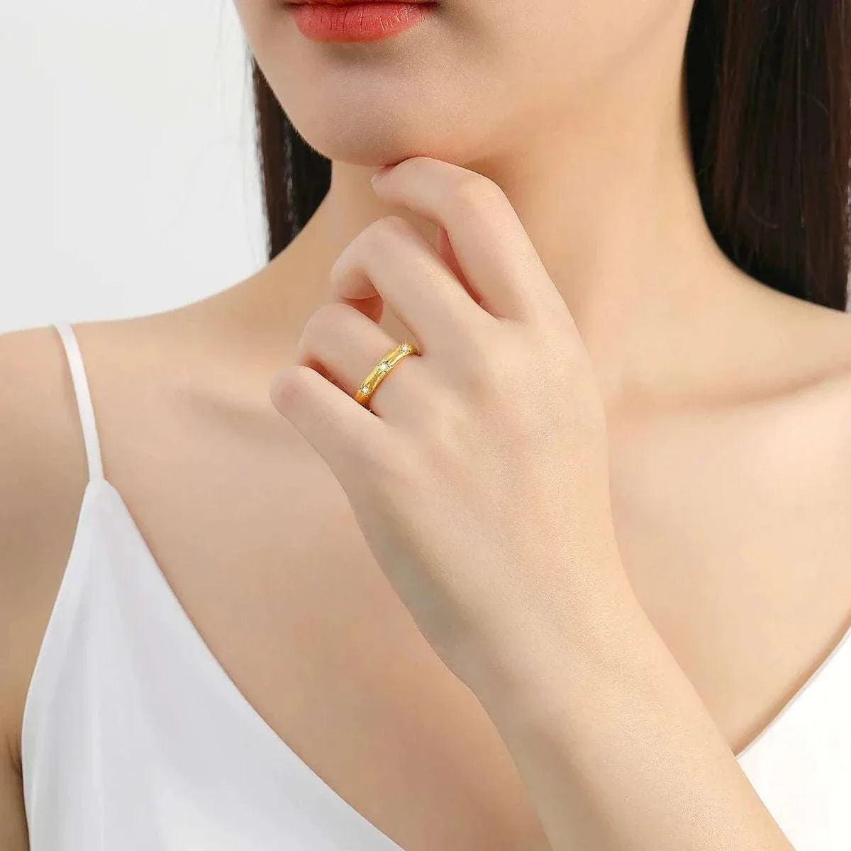 18K gold moissanite luxury diamond ring on woman's finger, showcasing elegance and craftsmanship.