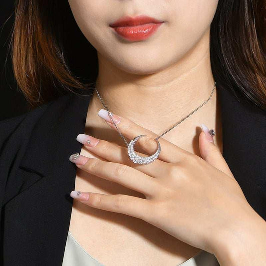 Crescent moon moissanite necklace in 925 silver on woman.