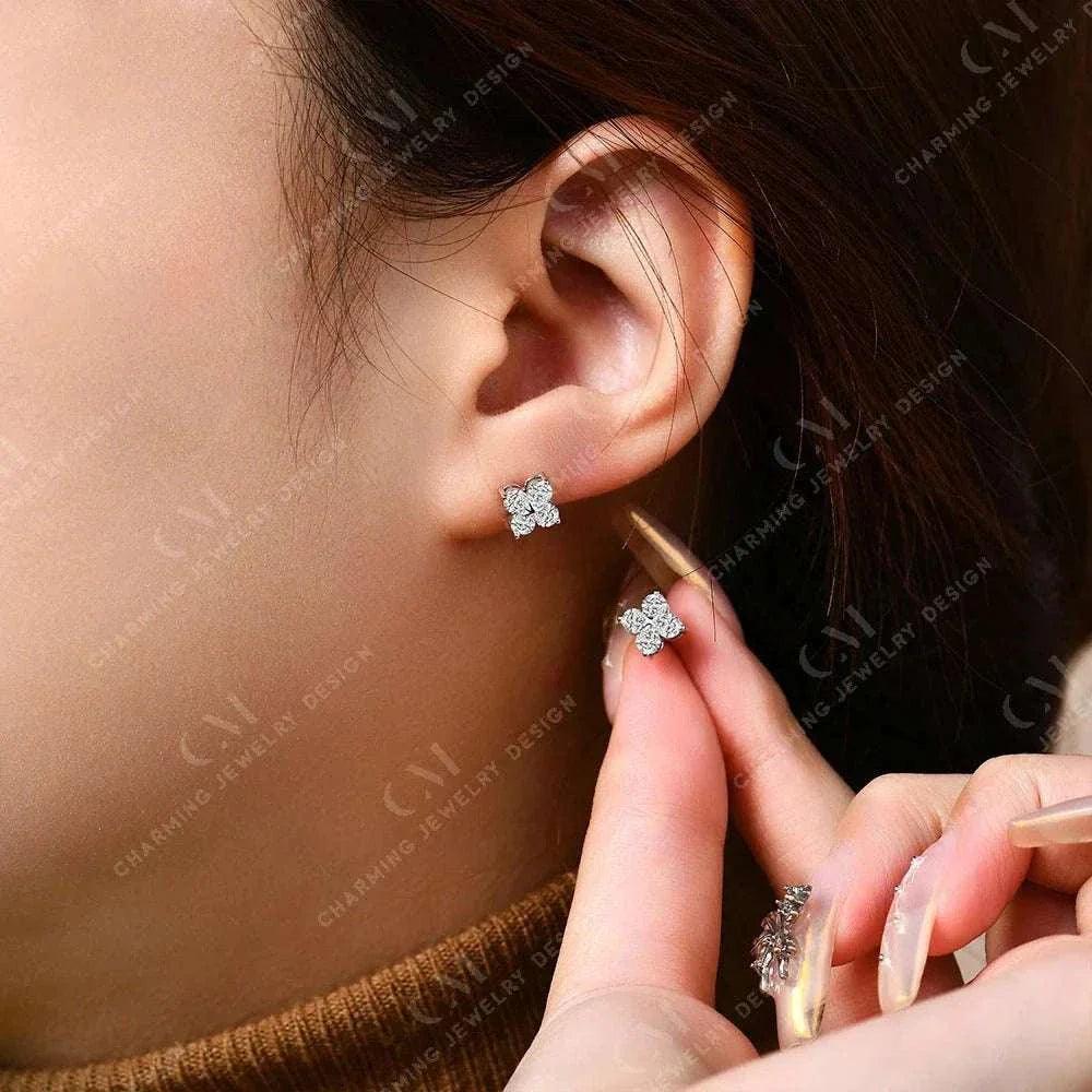 Dazzling moissanite flower earrings in gold/silver on model's ear.