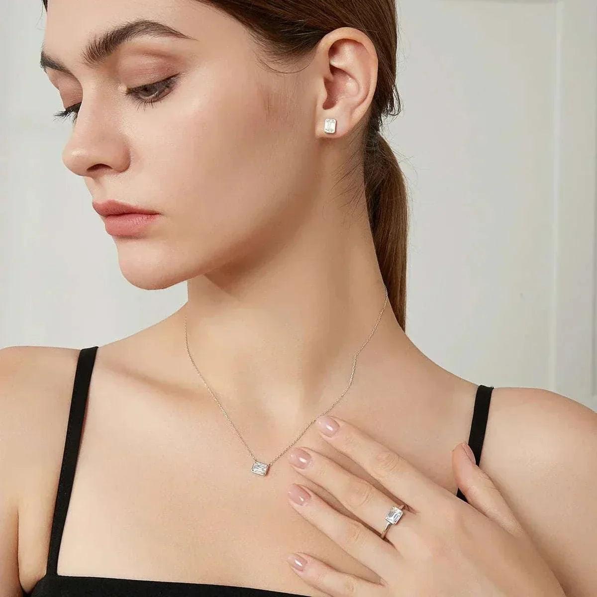 Elegant woman wearing 1.2CT moissanite emerald cut earrings.