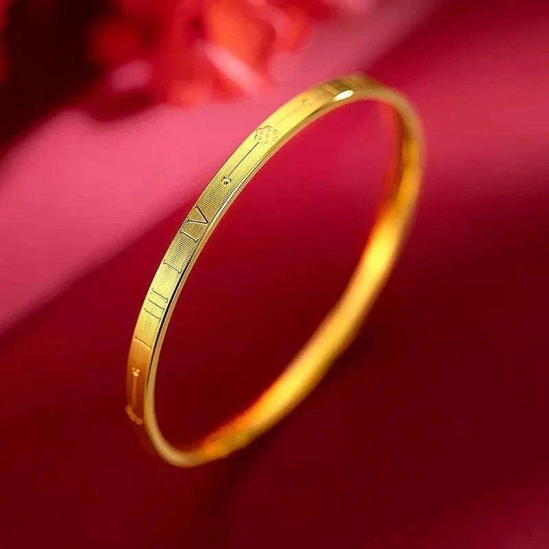 Elegant 22K gold women's bracelet against red background.