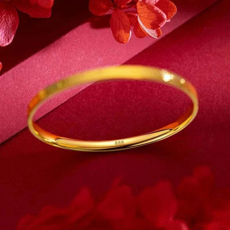 Elegant 22K gold women's bracelet on red background, perfect wedding gift.