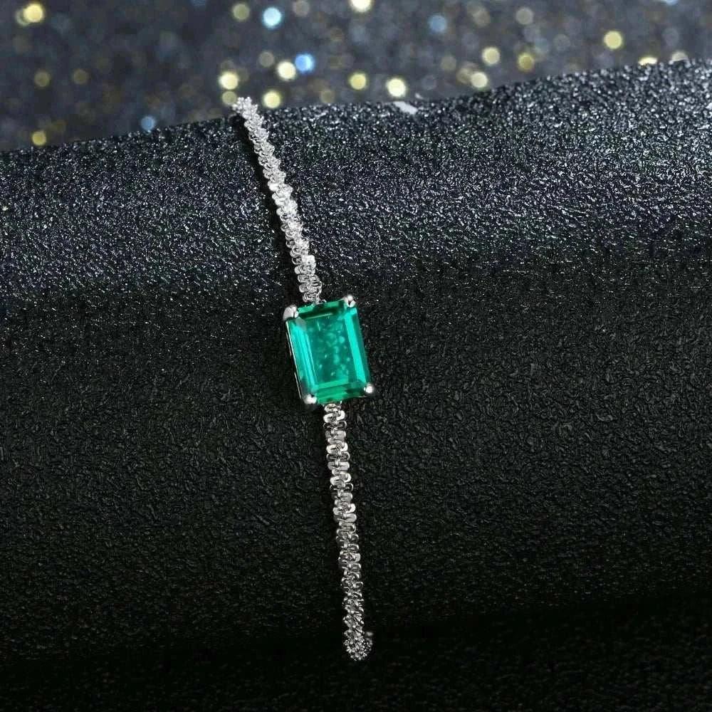elegant 925 silver emerald moissanite bangle sparkling on black surface
