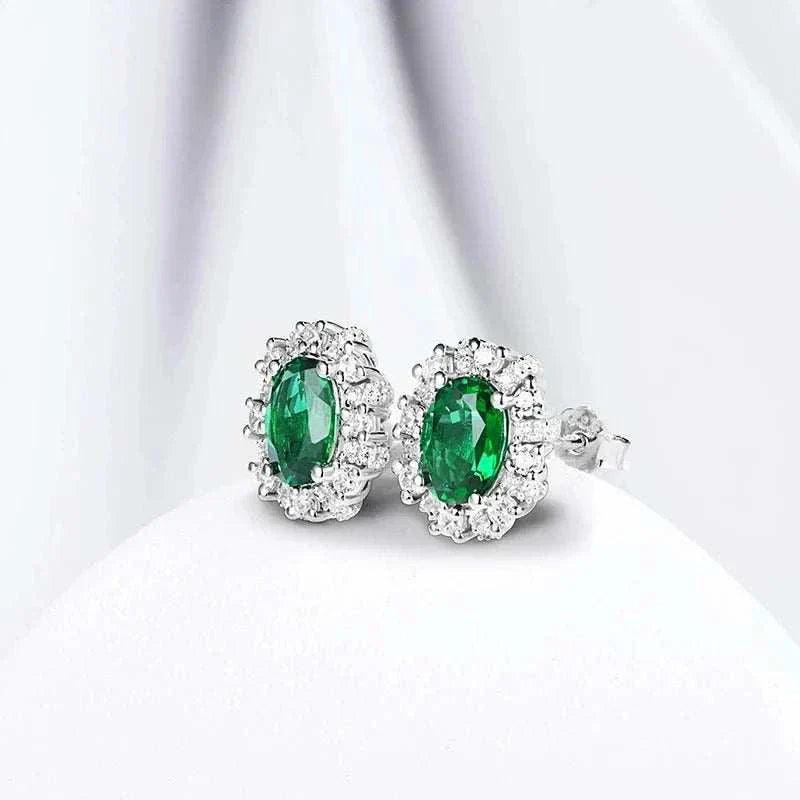 Elegant 925 silver emerald stud earrings with oval-cut lab-created emeralds and rhodium plating, showcasing timeless sophistication and sustainability.