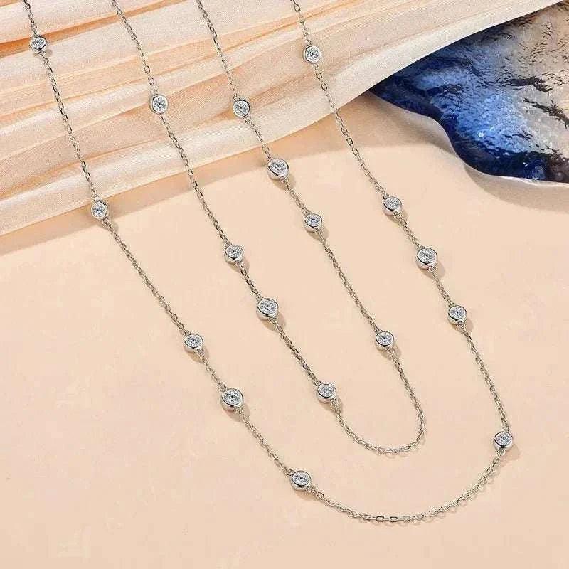 Elegant 925 silver moissanite necklace with round-cut stones on a delicate silver chain.