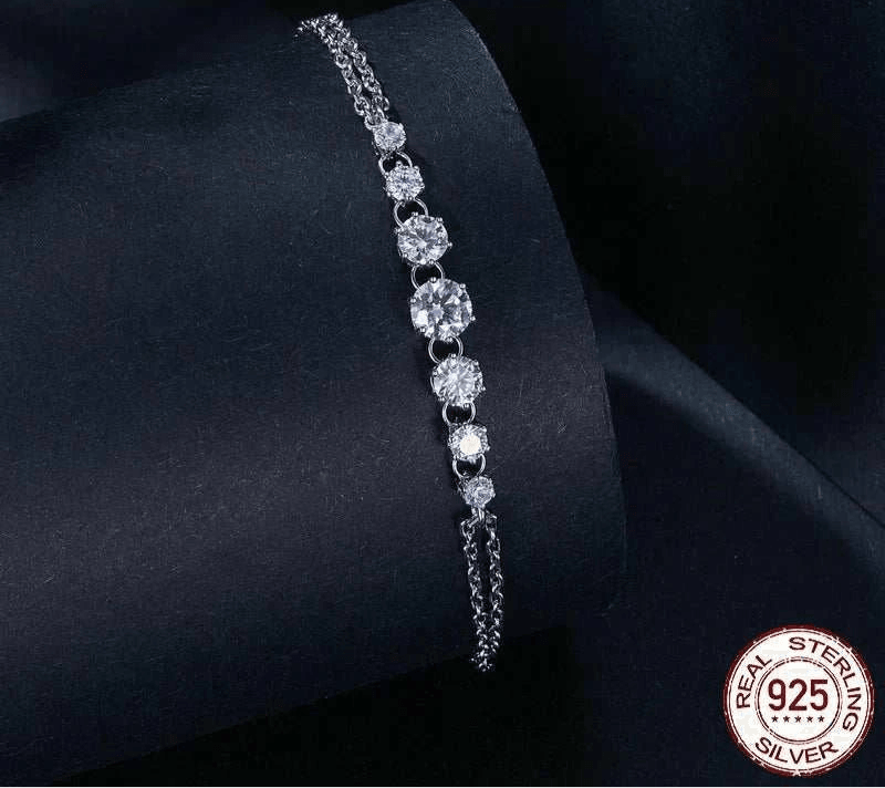 Elegant adjustable moissanite bracelet on black background, featuring sparkling stones in platinum-plated sterling silver.