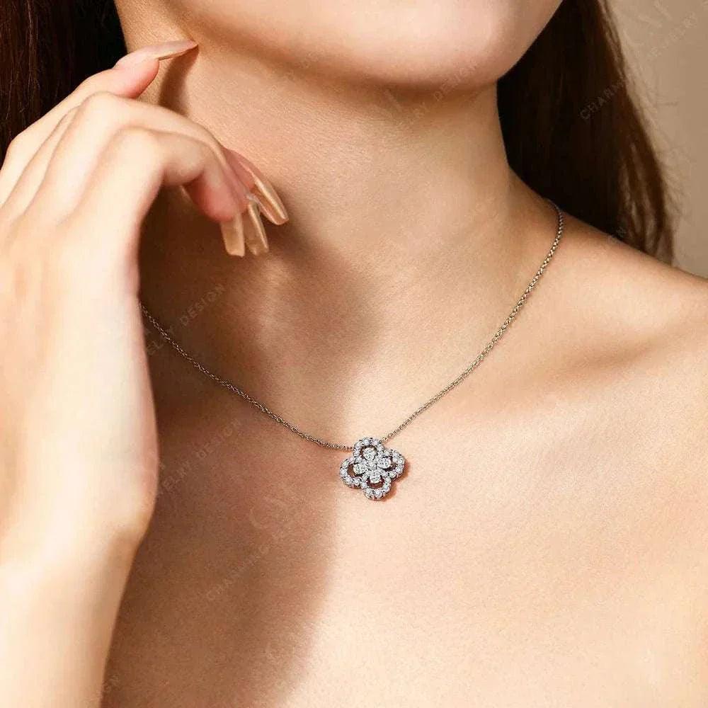 Elegant moissanite flower necklace in sterling silver worn on a woman's neck.