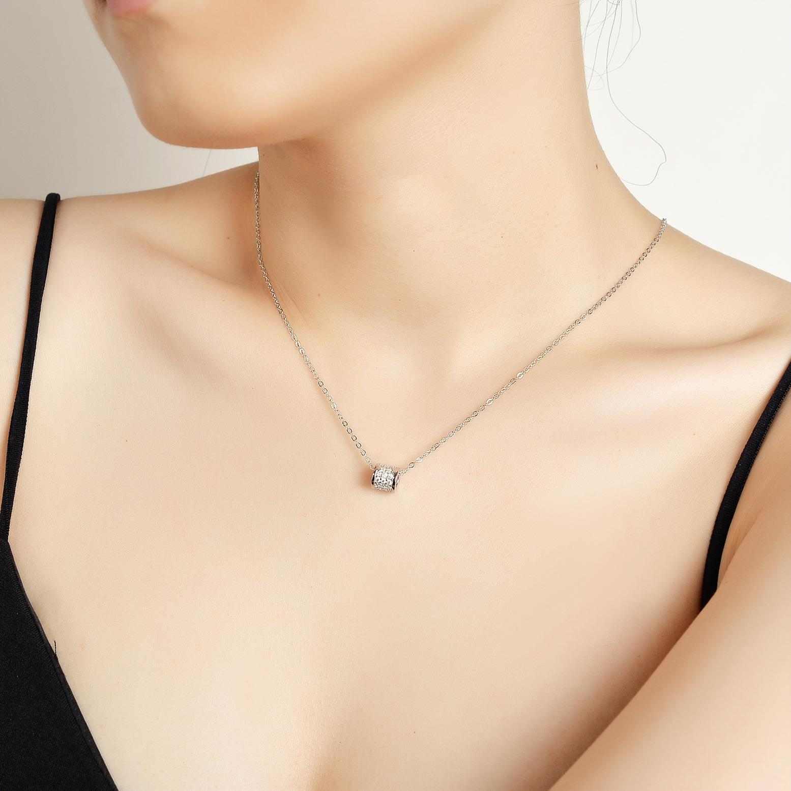 Woman wearing an elegant moissanite sterling silver necklace.