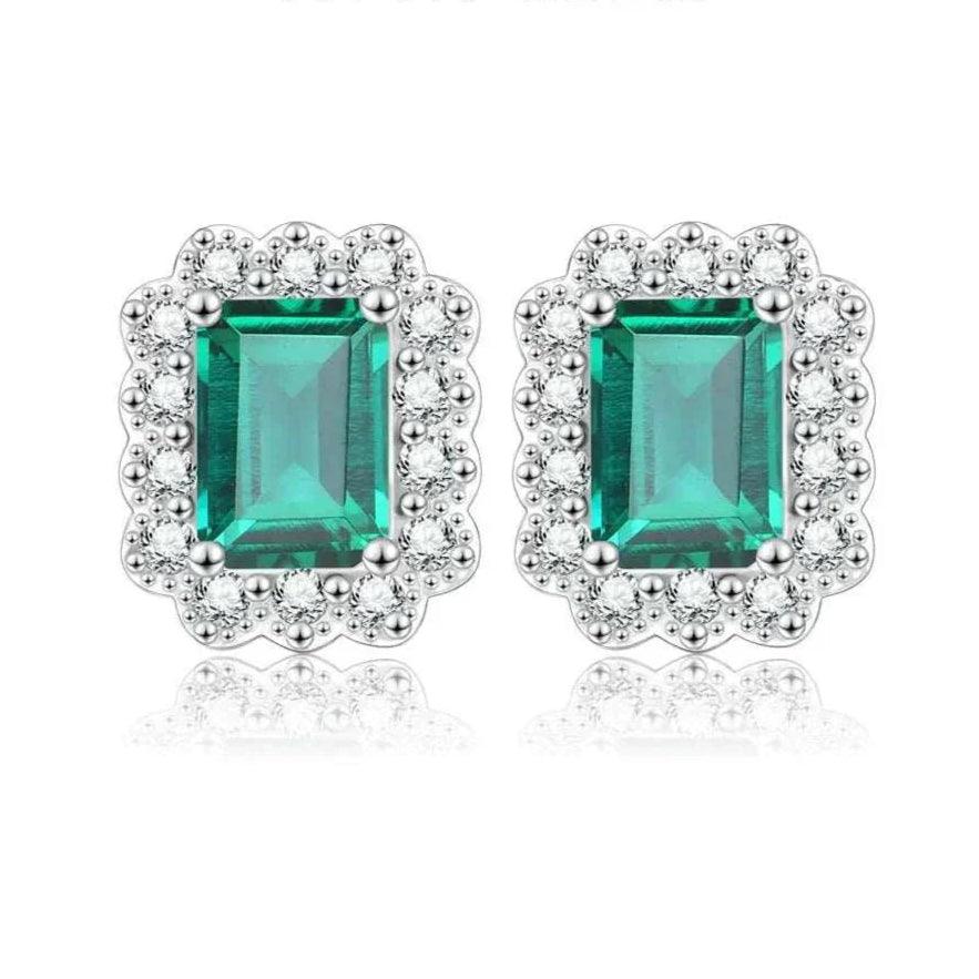 Elegant octagon cut emerald stud earrings in sterling silver with rhodium plating.