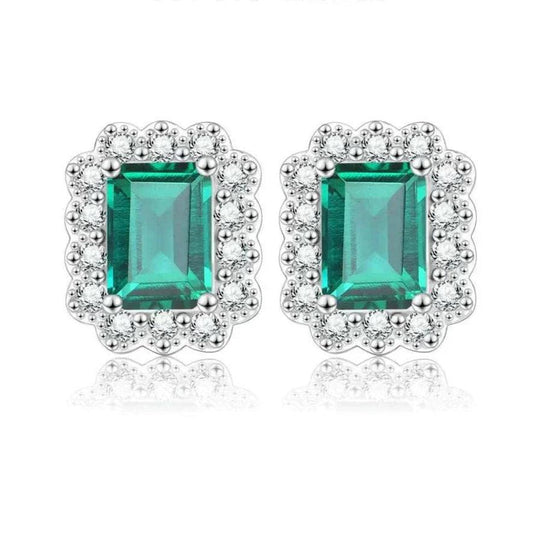 Elegant octagon cut emerald stud earrings in sterling silver with rhodium plating.