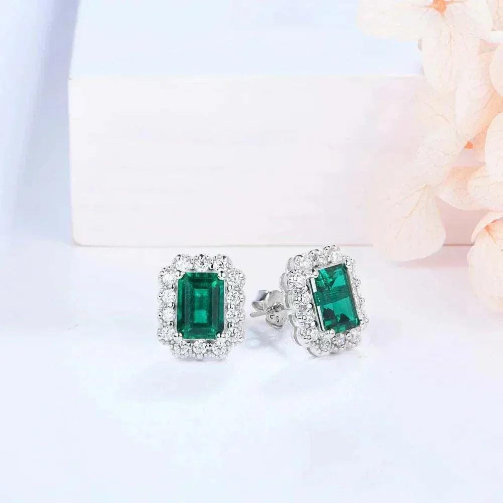 Elegant octagon cut emerald stud earrings in sterling silver with rhodium plating.