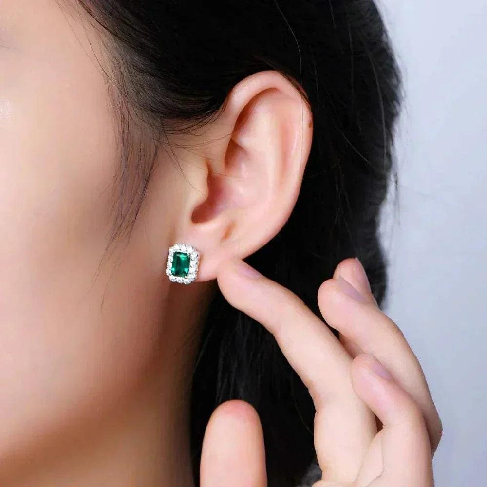 Elegant octagon cut emerald stud earrings in sterling silver.