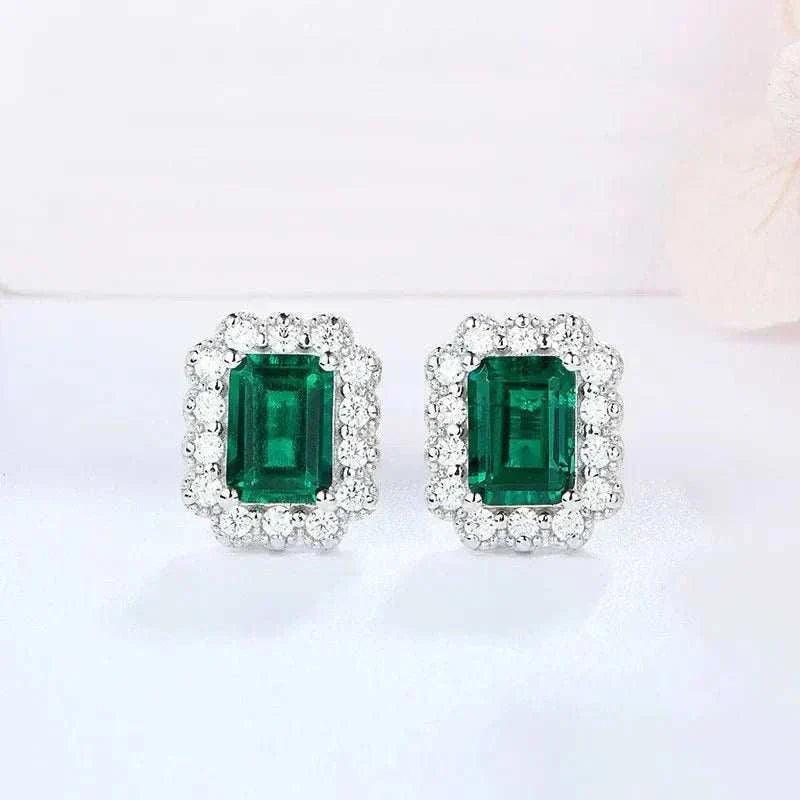 Elegant octagon cut emerald stud earrings with sparkling green lab-grown emeralds and sterling silver setting.