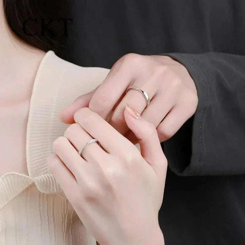 Elegant Platinum Moissanite Couples Ring Set on hands, showcasing minimalist design and brilliant moissanite stones.