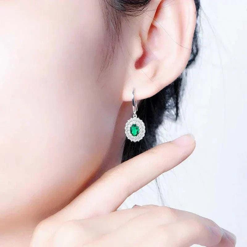 Emerald Moissanite Dangle Earrings on ear showcasing natural elegance.