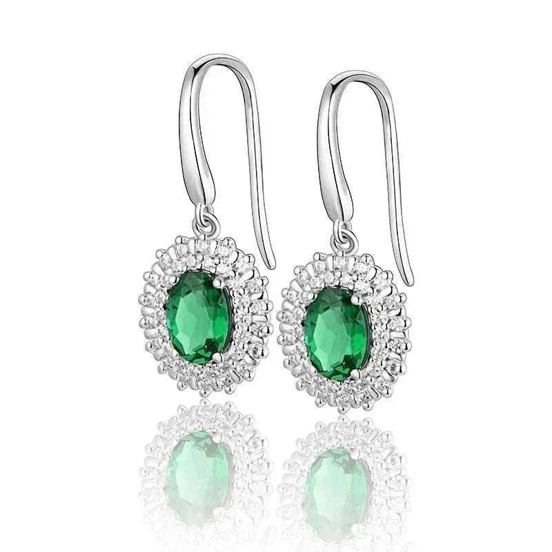 Emerald Moissanite dangle earrings in 925 sterling silver with oval VVS1 emeralds, showcasing natural elegance and luxury.