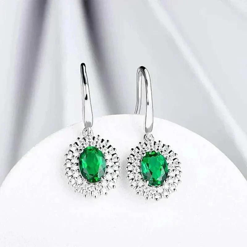 Emerald Moissanite dangle earrings in sterling silver with oval green stones, natural elegance.