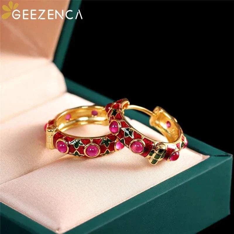 Gold plated red corundum hoop earrings in green box.