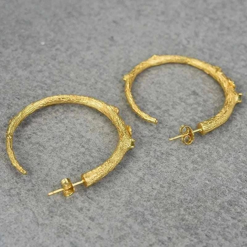 handmade vintage peridot 925 silver hoop earrings on textured surface