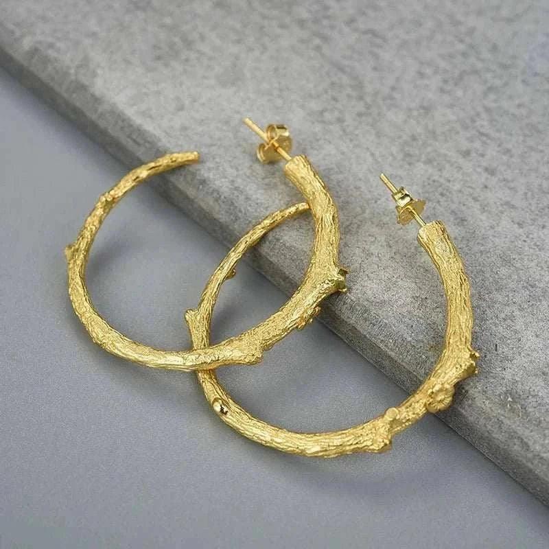 handmade vintage peridot 925 silver hoop earrings with rustic design on gray background