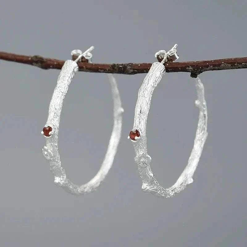 handmade vintage peridot 925 silver hoop earrings with peridot stones on display