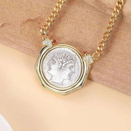 Janus vintage two-faces coin necklace on gold chain, showcasing dual-faced ancient coin design.
