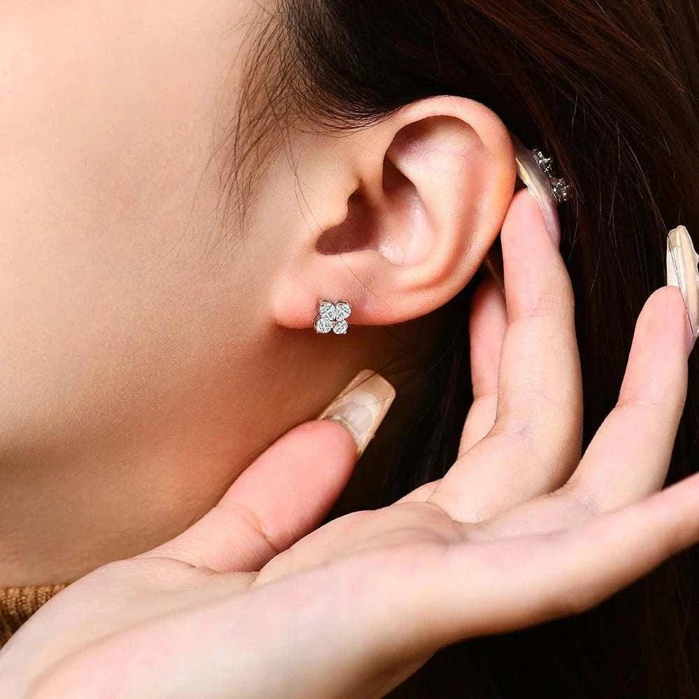 Elegant luxury moissanite clover earrings in white gold on ear, showcasing sophisticated design and shine.