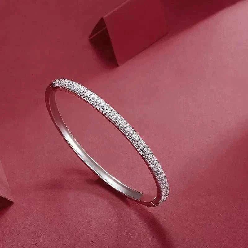 Luxury S925 Sterling Silver Moissanite Cuff Bracelet on red background.