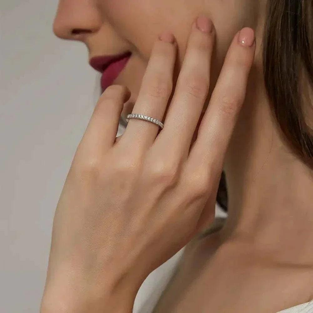moissanite full eternity ring in sterling silver worn on woman's finger