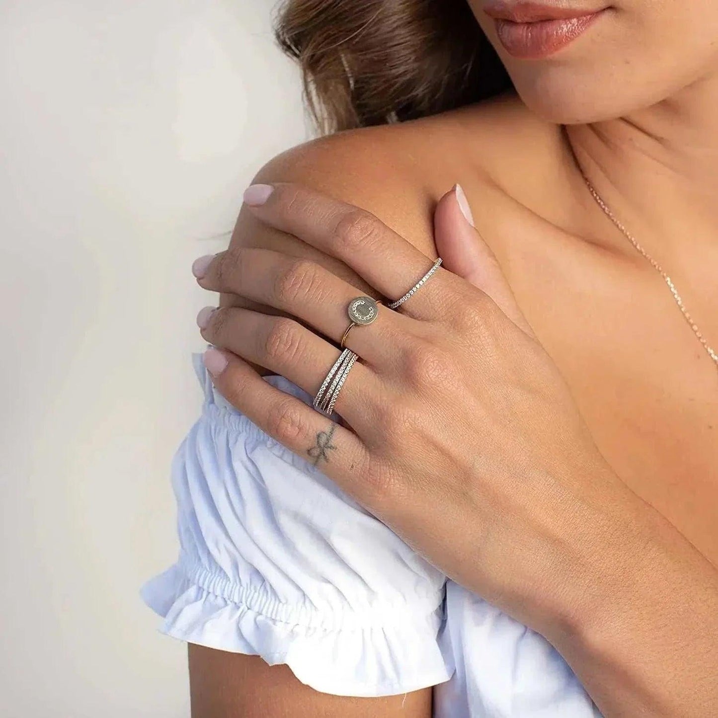 Moissanite full eternity ring in sterling silver on a woman's hand, showcasing elegant craftsmanship.