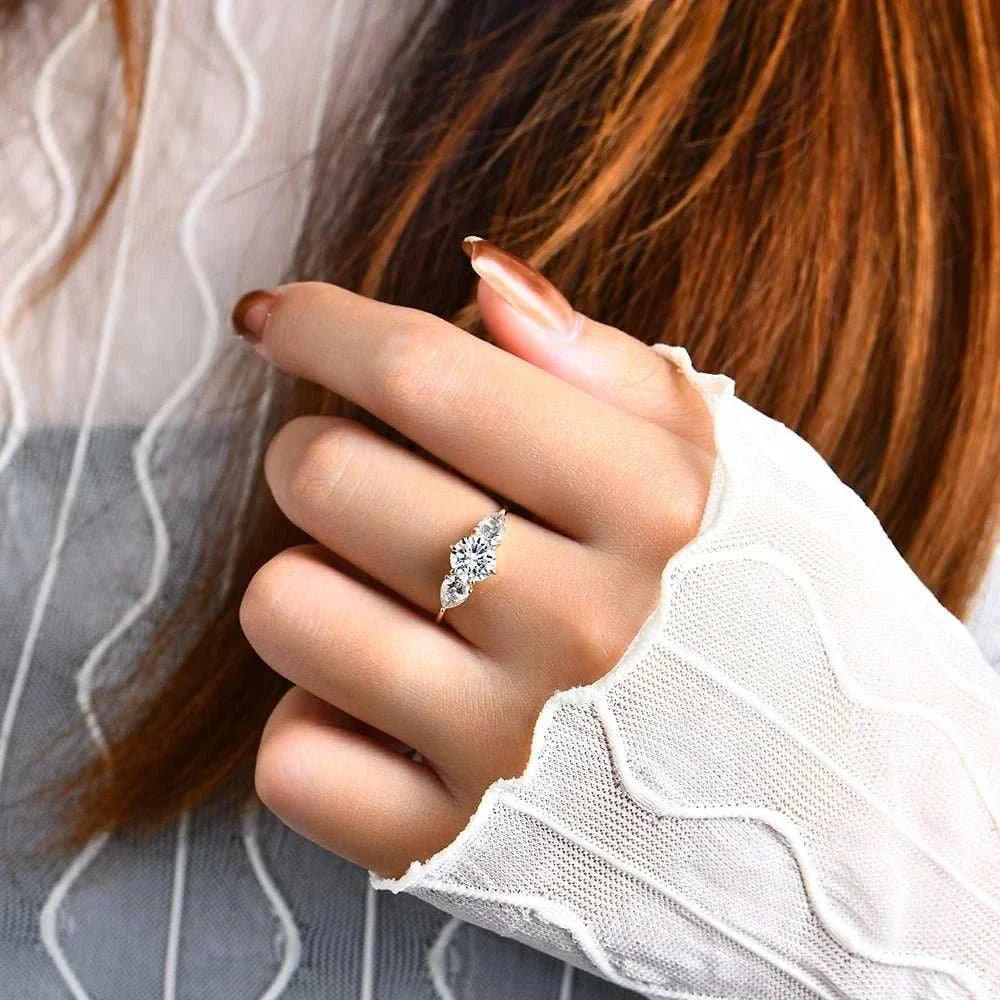 Moissanite Halo Engagement Ring in Yellow Gold, worn on a woman's hand, showcasing its dazzling brilliance and elegant design.