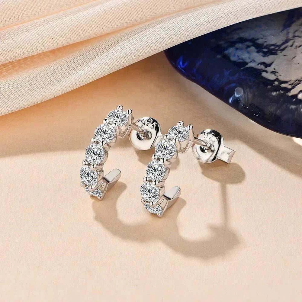 Moissanite stud earrings, elegant diamond alternative, showcased against a soft backdrop.