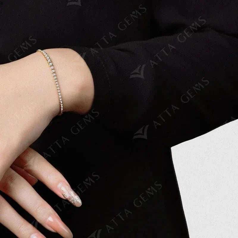 Moissanite tennis bracelet in 18k gold on wrist showcasing elegance and luxury.