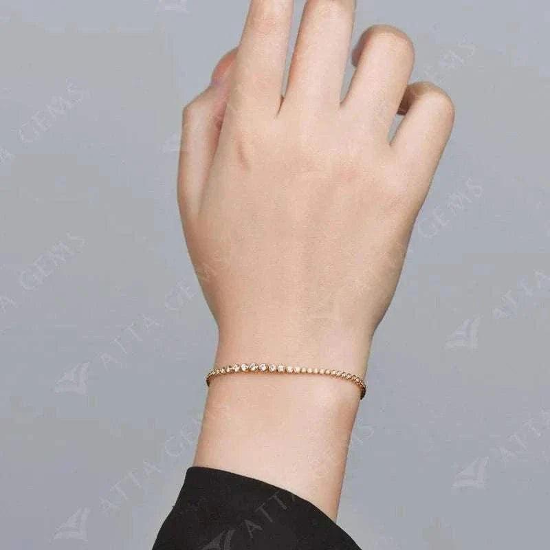 Moissanite tennis bracelet in 18k gold on wrist.