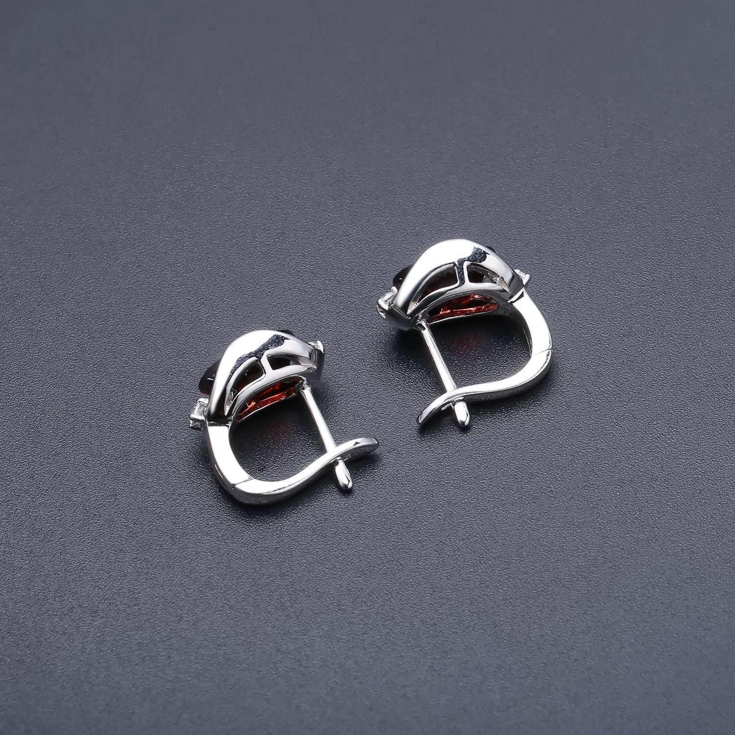 s925 silver natural garnet stud earrings on a dark background.