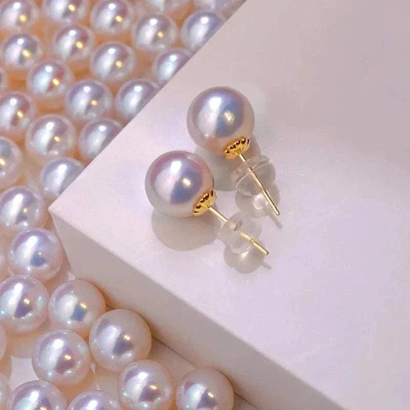 TIYINUO 18K gold natural pearl stud earrings on display with surrounding pearls.